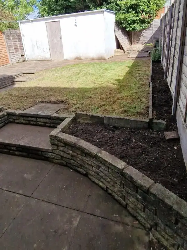 Waist-high grass over a buried wall — after the work was completed